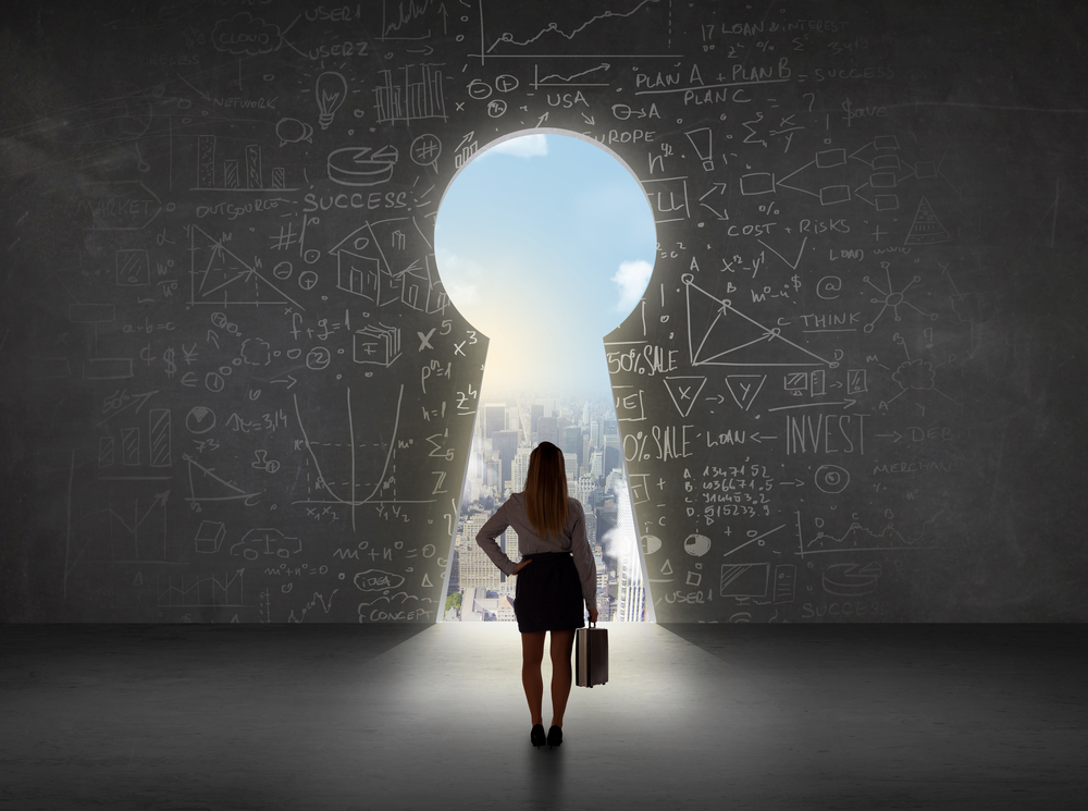 Business woman looking at keyhole with bright cityscape concept background Business woman looking at keyhole with bright cityscape concept background